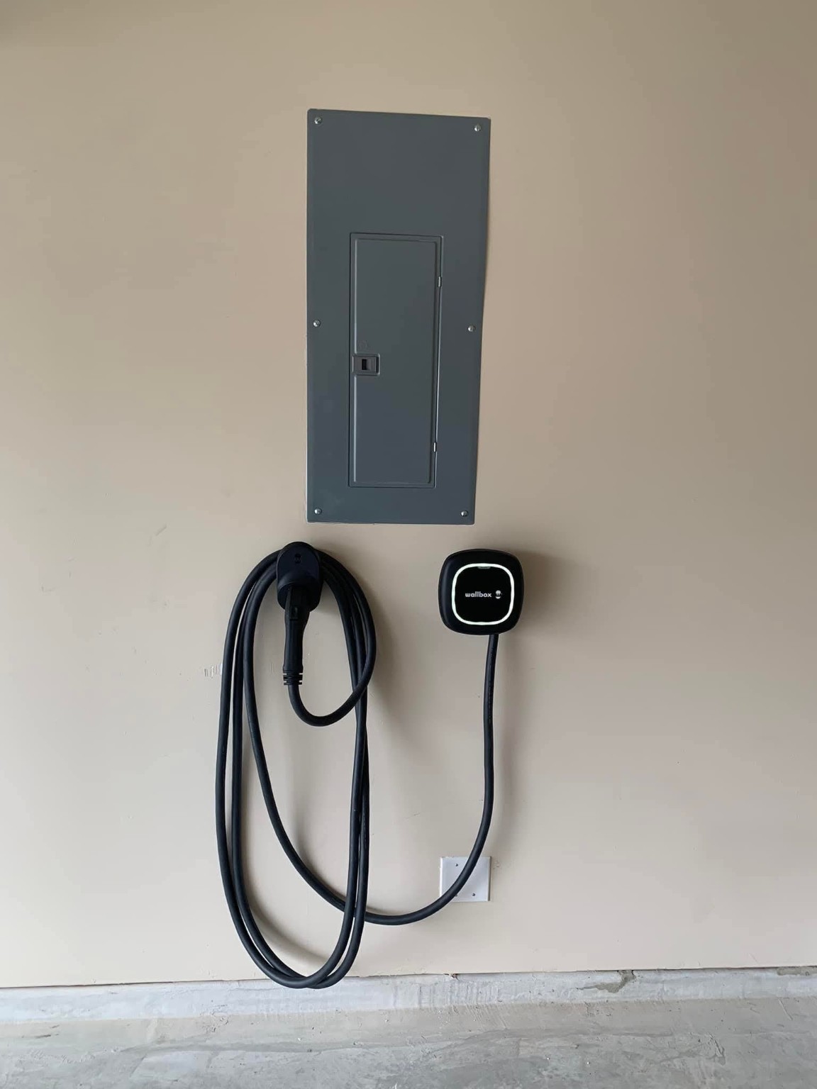 Clean Wallbox EV charger installation beside an electrical panel